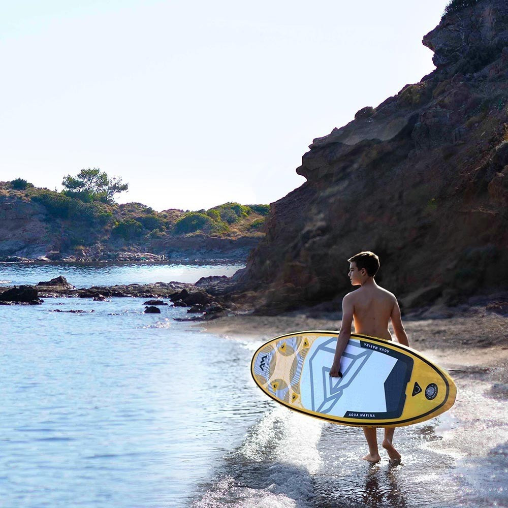 obrazek kluk nese paddleboard auqa marina vibrant